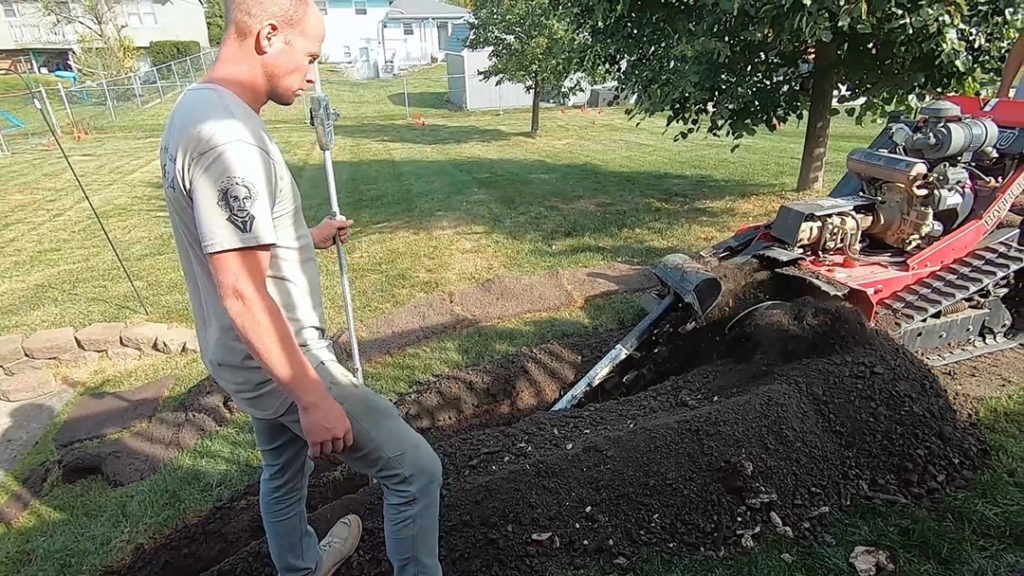 digging a trench for a drain tile