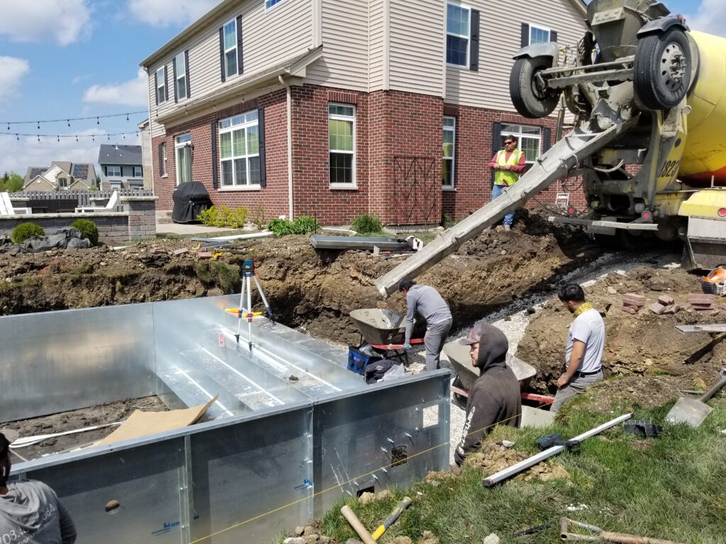 Custom inground pool installation with crew