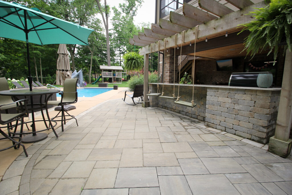 Custom poolscape with outdoor kitchen and pergola